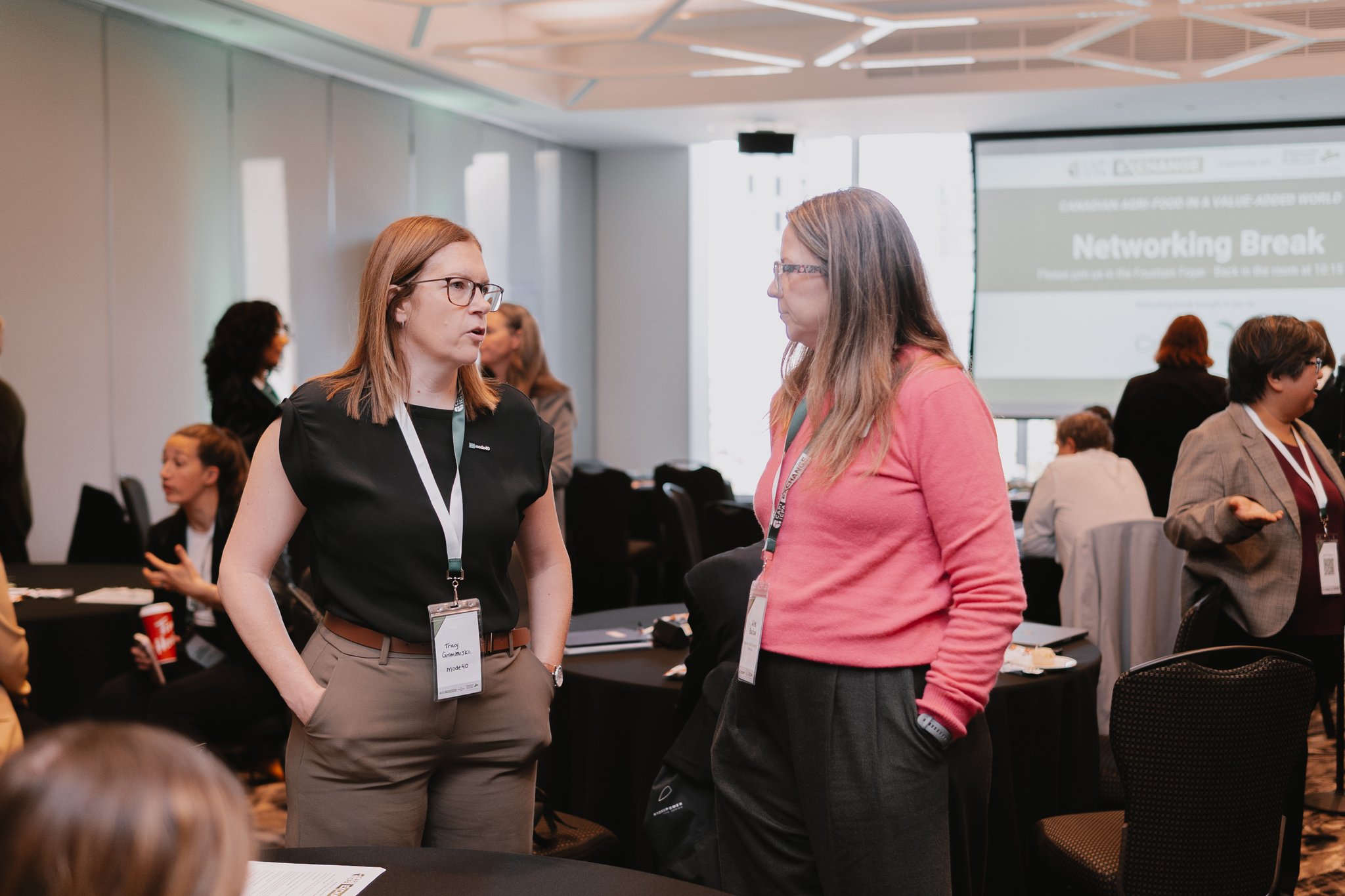 Tracy Gromniski in conversation with another attendee during a networking break at the CAPI Exchange Conference